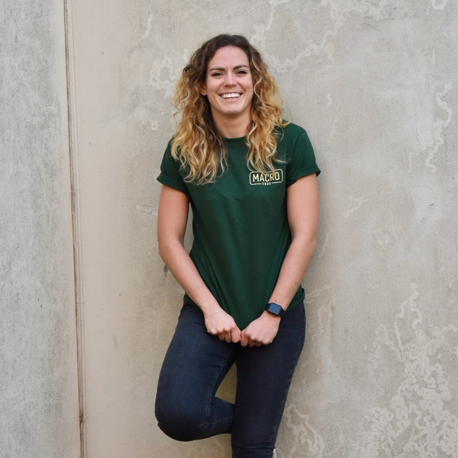 Kirsty-Lee Griffiths Founder, Macro Food, leaning against wall smiling