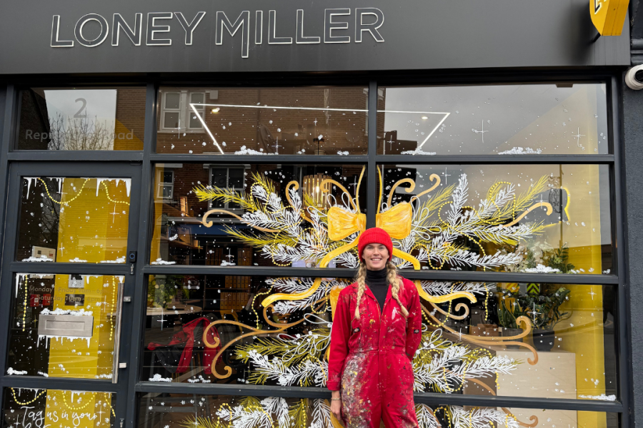 Hannah Sykes outside the Loney Miller window she painted